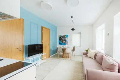 a living room with a couch and a table at Observation Deck Apartments in Kaunas