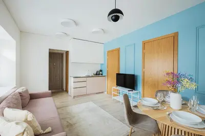 a living room with a couch and a table at Observation Deck Apartments in Kaunas