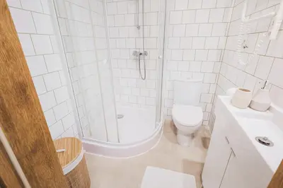a bathroom with a shower and a toilet and a sink at Observation Deck Apartments in Kaunas