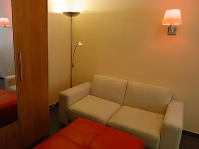 a living room with a couch and a lamp at 3 rooms apartment with balcony in Kaunas