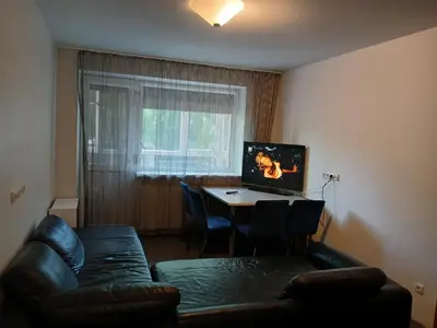 a living room with a couch and a table at 3 rooms apartment with balcony in Kaunas