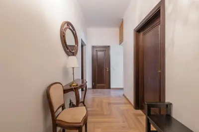 a hallway with a table and a chair and a mirror at Riverside apartment in Vilnius