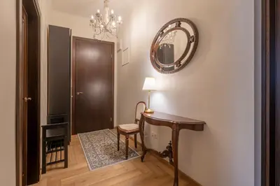 a hallway with a table and a chair and a mirror at Riverside apartment in Vilnius