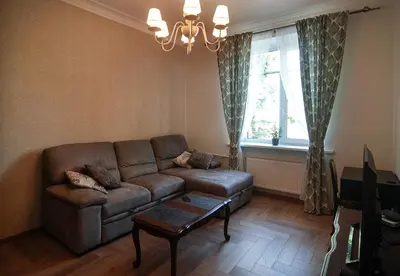 a living room with a couch and a window at Riverside apartment in Vilnius
