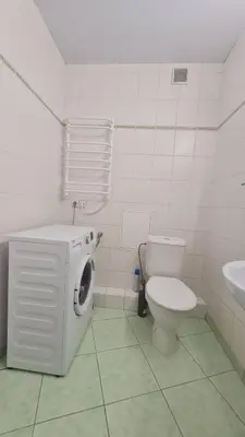 a bathroom with a washing machine and a toilet at Rehouse, Vilniaus 45 in Vilnius