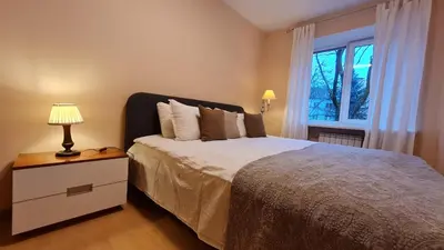a bedroom with a large bed and a window at Rehouse, Vilniaus 45 in Vilnius