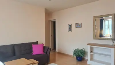 a living room with a couch and a mirror at Rehouse, Vilniaus 45 in Vilnius