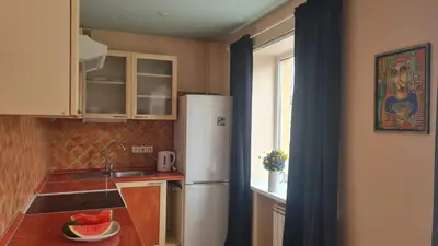 a small kitchen with a white refrigerator and a sink at Rehouse, Vilniaus 45 in Vilnius