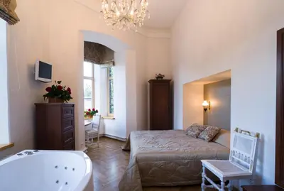 a bathroom with a bed and a tub and a sink at Florens guesthouse in Vilnius