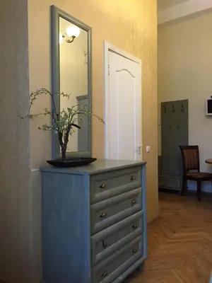 a dresser with a mirror on top of it at Florens guesthouse in Vilnius