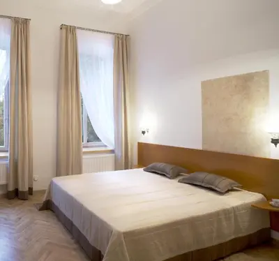 a bedroom with a large bed in front of a window at Florens guesthouse in Vilnius