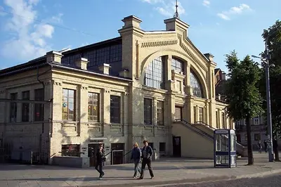 a group of people walking in front of a building at Florens guesthouse in Vilnius