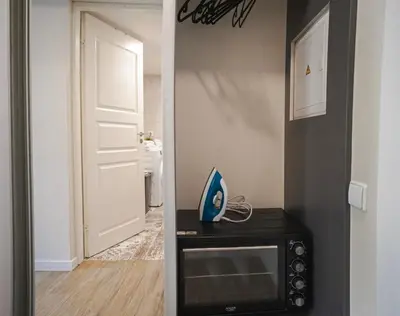 a door leading into a room with a microwave at Cozy Loft next to Main Station in Kaunas