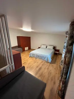 a bedroom with a bed and a couch in it at Svečių namelis in Kaunas