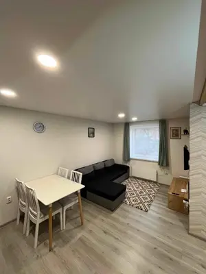 a living room with a couch and a table at Svečių namelis in Kaunas