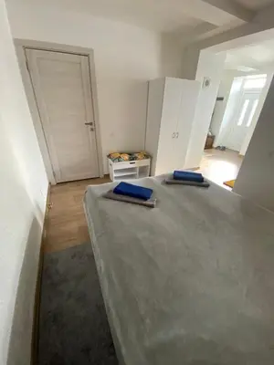 a room with a bed with two blue tupperware at Centro apartments Rokiškis in Rokiškis