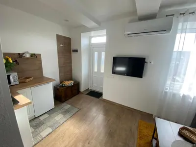 a living room with a flat screen tv on a wall at Centro apartments Rokiškis in Rokiškis
