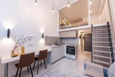 a kitchen and dining room with a table and chairs at Sigma Skyline Lofts by Reside Baltic in Vilnius