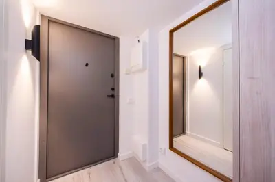 a door in a hallway with a mirror at Sigma Skyline Lofts by Reside Baltic in Vilnius