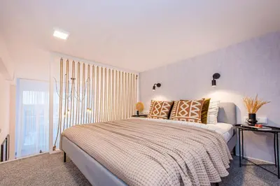 a bedroom with a large bed and a window at Sigma Skyline Lofts by Reside Baltic in Vilnius
