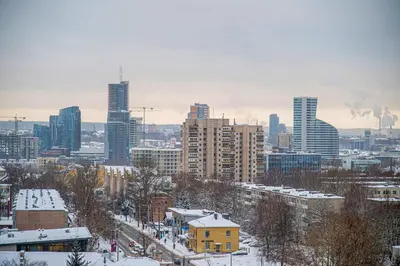 a view of a city in the snow with buildings at Sigma Skyline Lofts by Reside Baltic in Vilnius