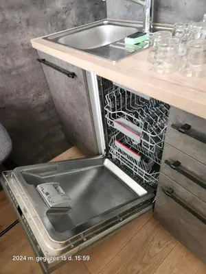 a dishwasher with its door open next to a sink at HaPPy iNN LUX Old Town Studio, Self Check in, Parking in Vilnius