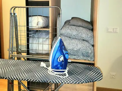 a blue vacuum cleaner sitting on top of a chair at HaPPy iNN LUX Old Town Studio, Self Check in, Parking in Vilnius