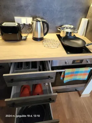 a kitchen counter with pots and pans on a stove at HaPPy iNN LUX Old Town Studio, Self Check in, Parking in Vilnius