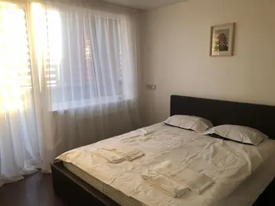 a bed with towels on it in a bedroom at Rent a Home in Panevėžys