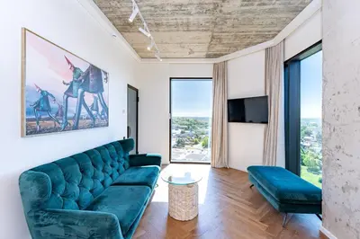 a living room with a couch and a tv at Panoramic View 1 BD Apartment by Domvia in Kaunas