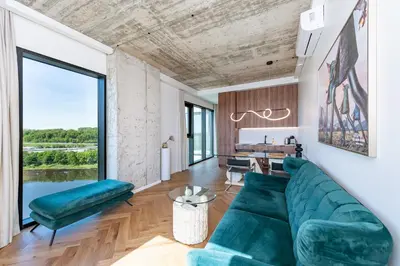 a living room with a green couch and a table at Panoramic View 1 BD Apartment by Domvia in Kaunas