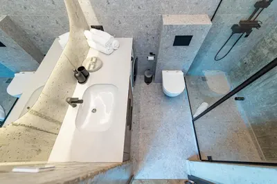 a bathroom with a sink and a toilet at Panoramic View 1 BD Apartment by Domvia in Kaunas