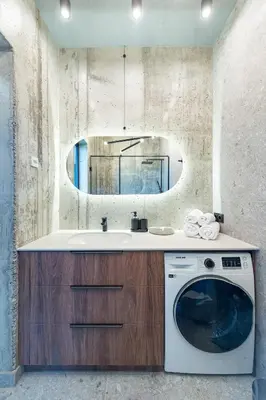a bathroom with a washing machine and a mirror at Panoramic View 1 BD Apartment by Domvia in Kaunas