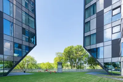 a rendering of a tall building next to a grass field at Panoramic View 1 BD Apartment by Domvia in Kaunas