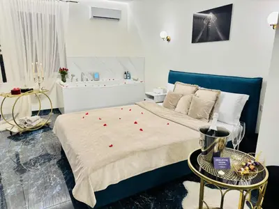 a bedroom with a bed with red roses on it at Ž Šančių- Apartamentai in Kaunas