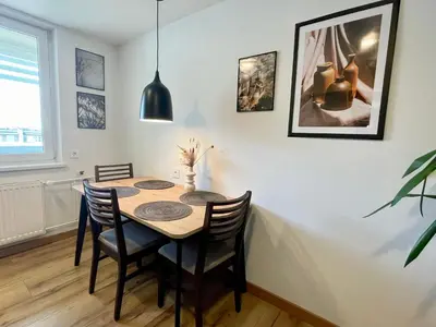 a dining room with a table and chairs at Liepų Apartamentai in Molėtai