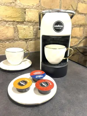 a coffee maker with two cups on a counter at Green Bridge Studio in Vilnius