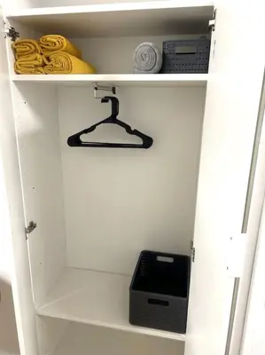 a white closet with a shelf with a toaster on it at Green Bridge Studio in Vilnius