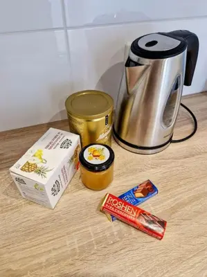 a counter top with a coffee pot and a box of peanuts at Butas šalia parko in Radviliškis