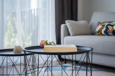 two tables in a living room with a book on them at Lazdyneliu Vingis, free underground parking, long stays welcome in Vilnius