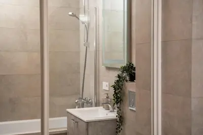 a bathroom with a sink and a shower at Lazdyneliu Vingis, free underground parking, long stays welcome in Vilnius