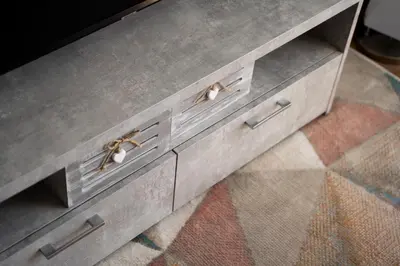 a gray dresser with silver handles on a rug at Lazdyneliu Vingis, free underground parking, long stays welcome in Vilnius