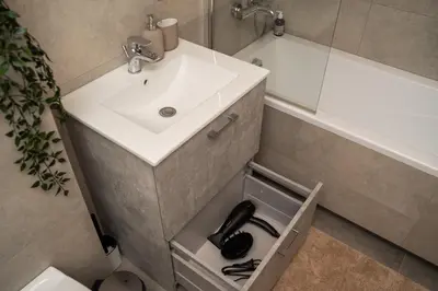 a bathroom with a sink and a mirror and a sink at Lazdyneliu Vingis, free underground parking, long stays welcome in Vilnius