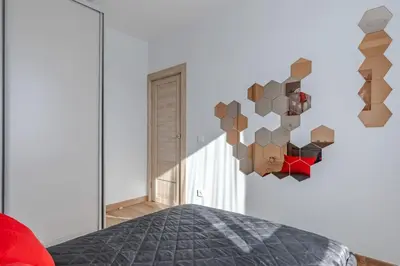 a bedroom with a bed and a mirror at Home sweet home, cozy apartments, free underground parking, long stays welcome in Vilnius