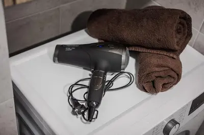 a hair dryer sitting on top of a sink at Home sweet home, cozy apartments, free underground parking, long stays welcome in Vilnius