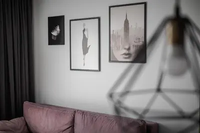 a living room with a couch and pictures on the wall at Home sweet home, cozy apartments, free underground parking, long stays welcome in Vilnius