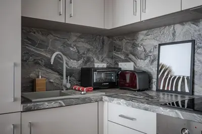 a kitchen counter with a sink and a microwave at Home sweet home, cozy apartments, free underground parking, long stays welcome in Vilnius