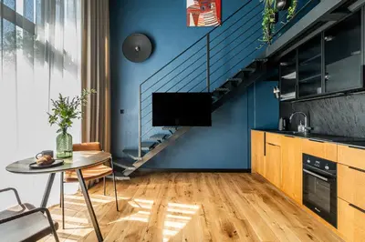 a living room with a table and a blue wall at Paupys lofts in Vilnius