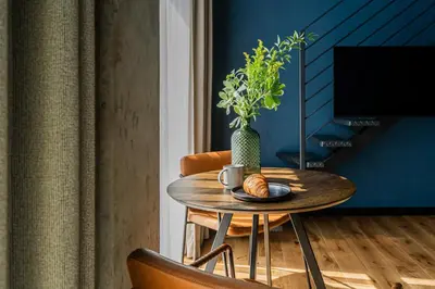 a table with a vase and a plate of food at Paupys lofts in Vilnius