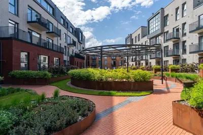 a courtyard with some plants and buildings at Paupys lofts in Vilnius